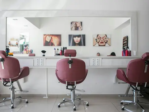 Salón de peluquería con sillones y espejos